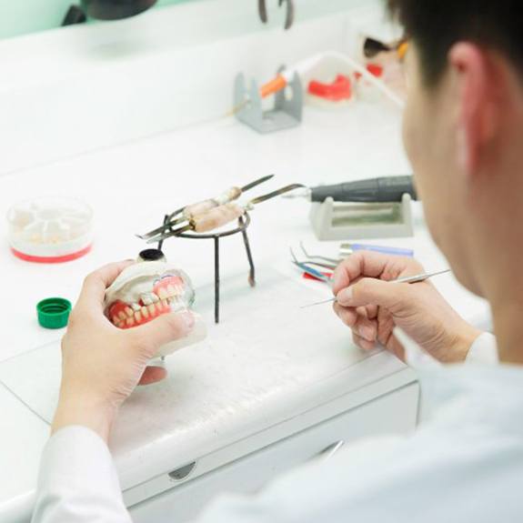 a lab technician constructing new dentures