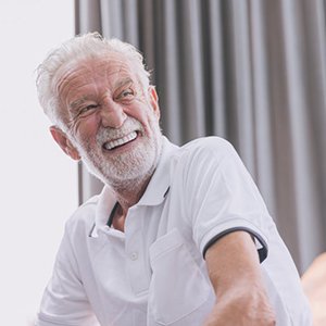 a man smiling with his brand-new dentures