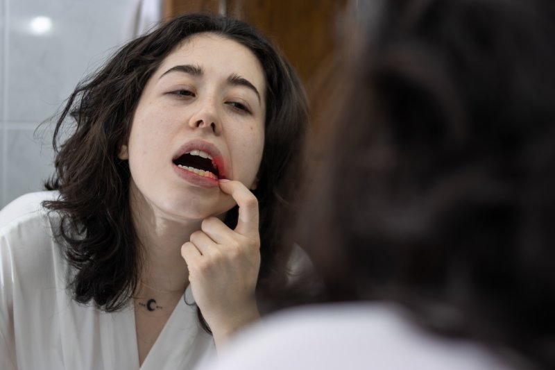 Patient checking their gums for gingivitis